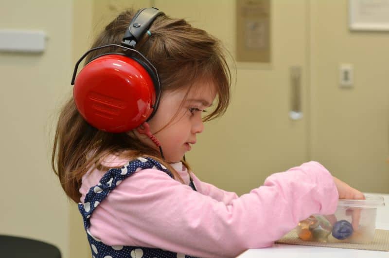 child wearing headphones in an auditory stimulation class