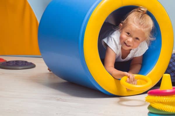 a vestibular stimulation therapy class - a kid in a play tunnel