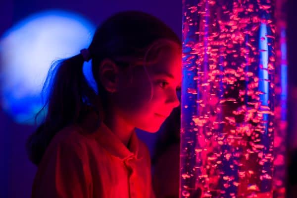 child looking at a lava lamp in visual stimulation room