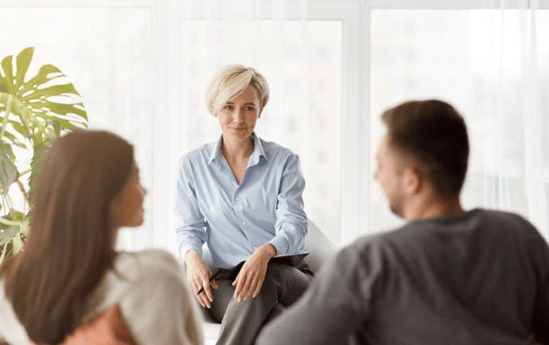 Couple talking to a woman