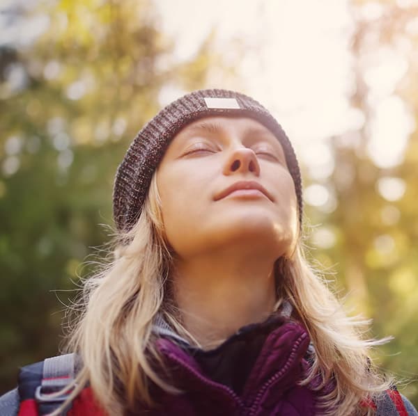 Woman breathes in fresh air