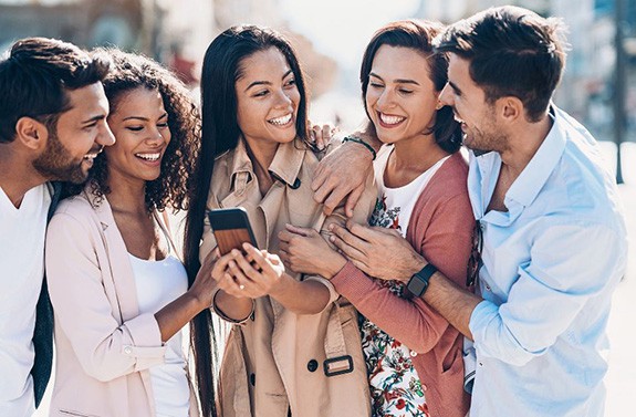 Friends have fun chatting with something on the phone